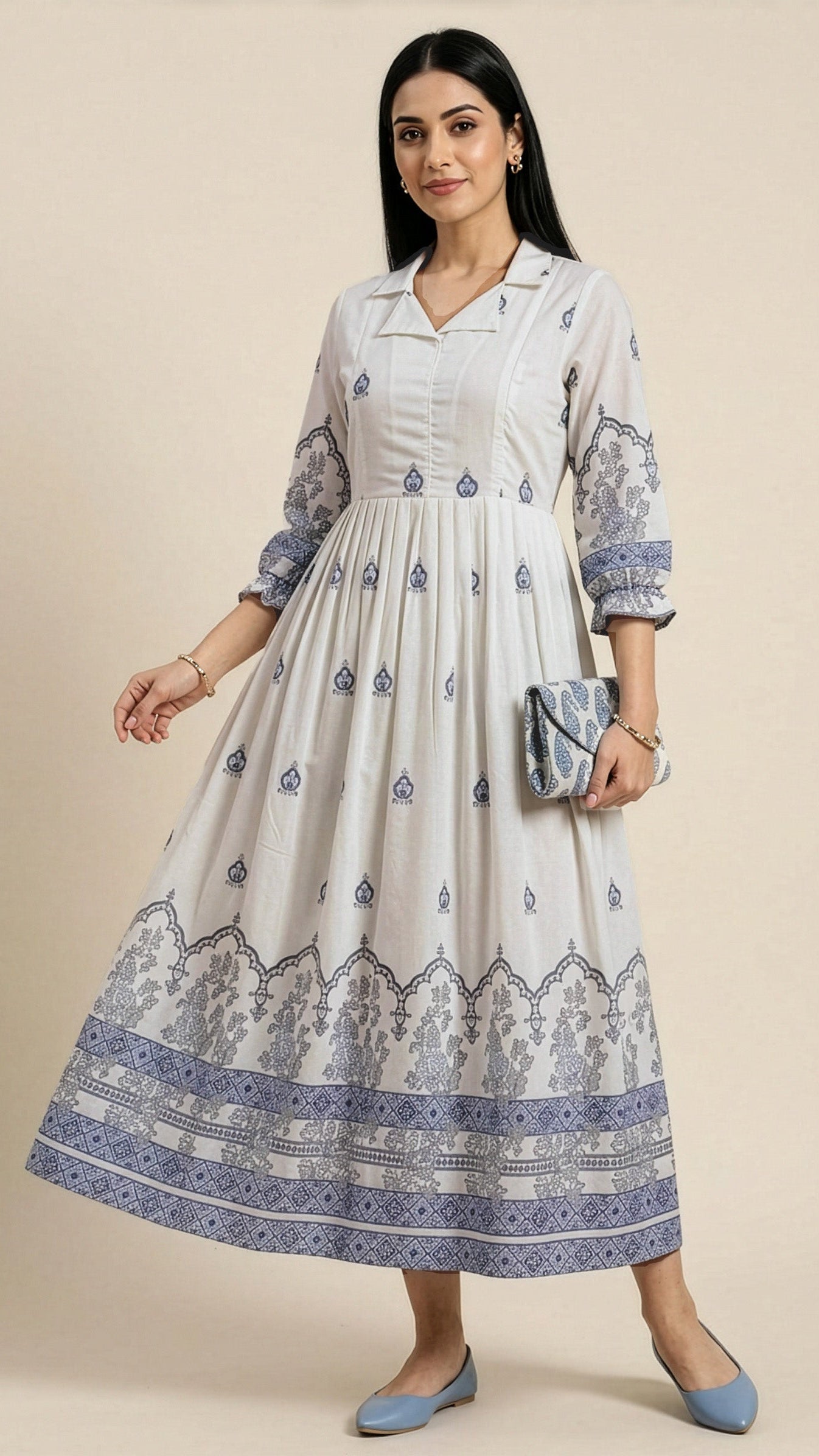Woman wearing a white dress with blue patterns on a beige background