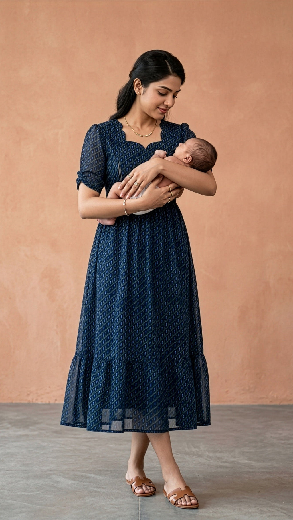 Maternity feeding dress in deep navy blue worn by a woman holding a baby, featuring invisible zip for easy feeding.