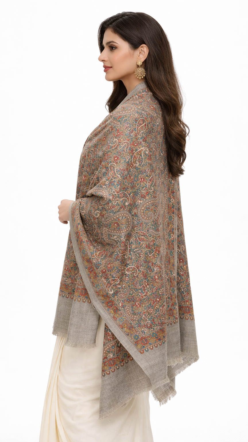 Woman wearing a patterned shawl over a white outfit on a white background