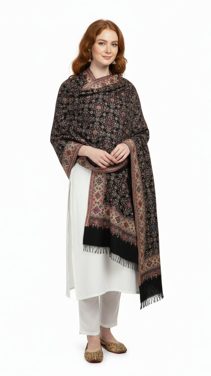 Woman wearing a patterned scarf over a white outfit on a white background