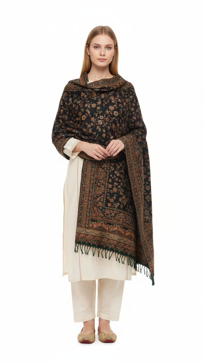 Woman wearing a patterned shawl over a white outfit on a white background