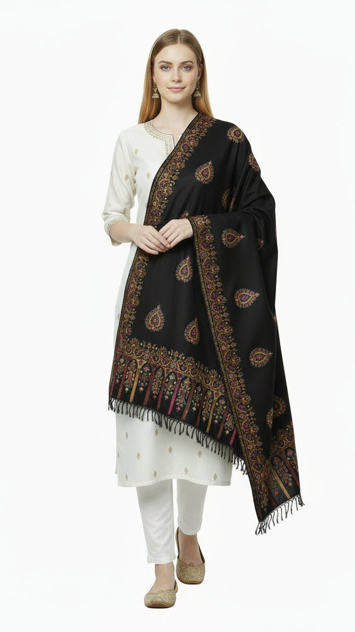 Woman wearing a black patterned scarf over a white outfit on a white background