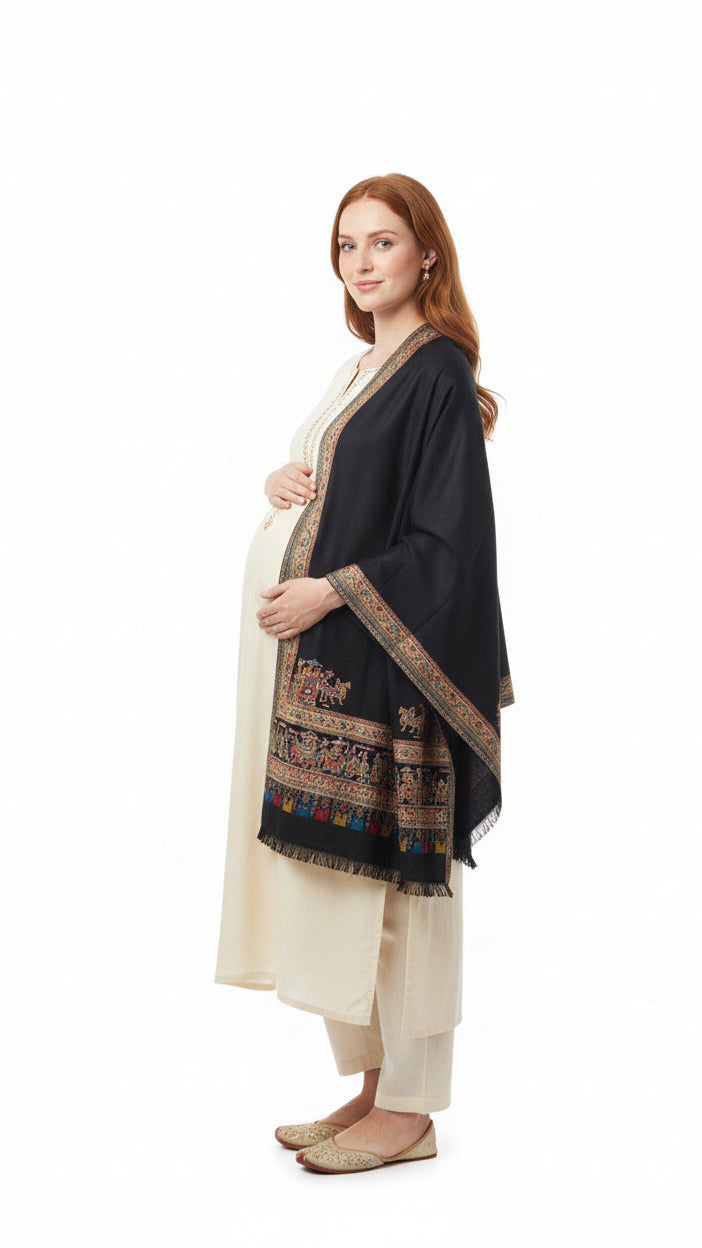 Woman wearing a black and beige traditional outfit on a white background