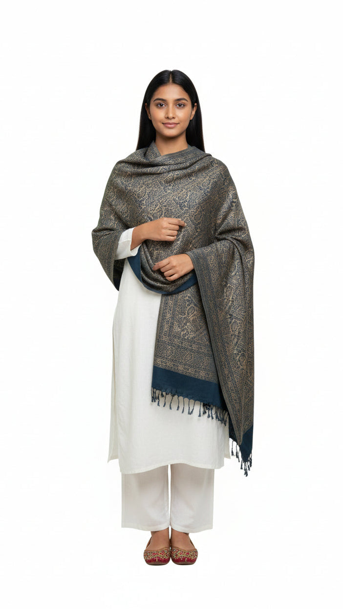 Woman wearing a patterned shawl over a white outfit on a white background