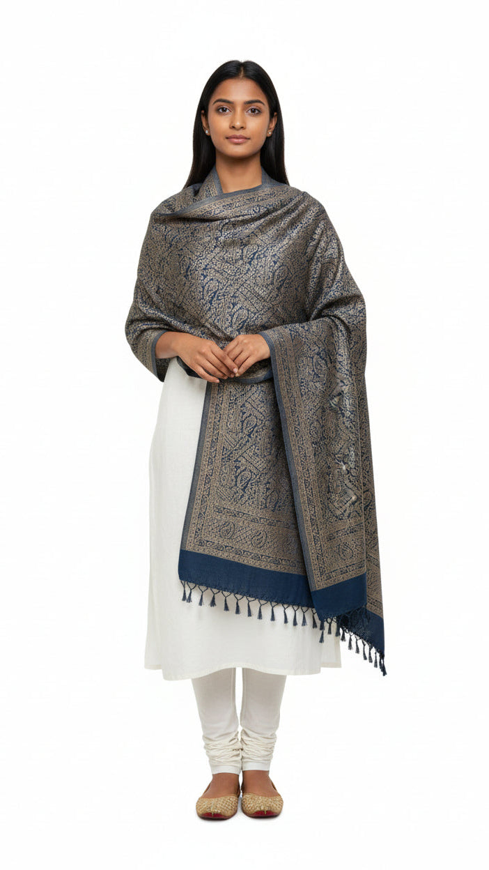 Woman wearing a patterned shawl over a white outfit on a white background