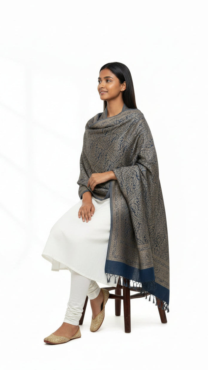 Woman sitting on a chair wearing a patterned scarf on a white background