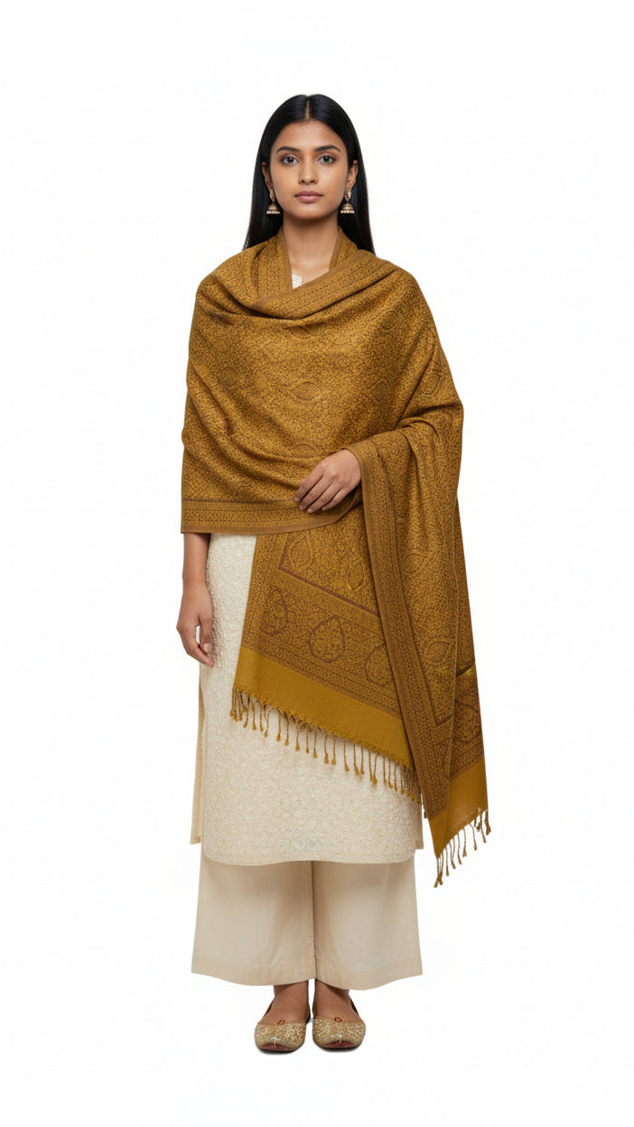 Woman wearing a mustard yellow patterned scarf on a white background