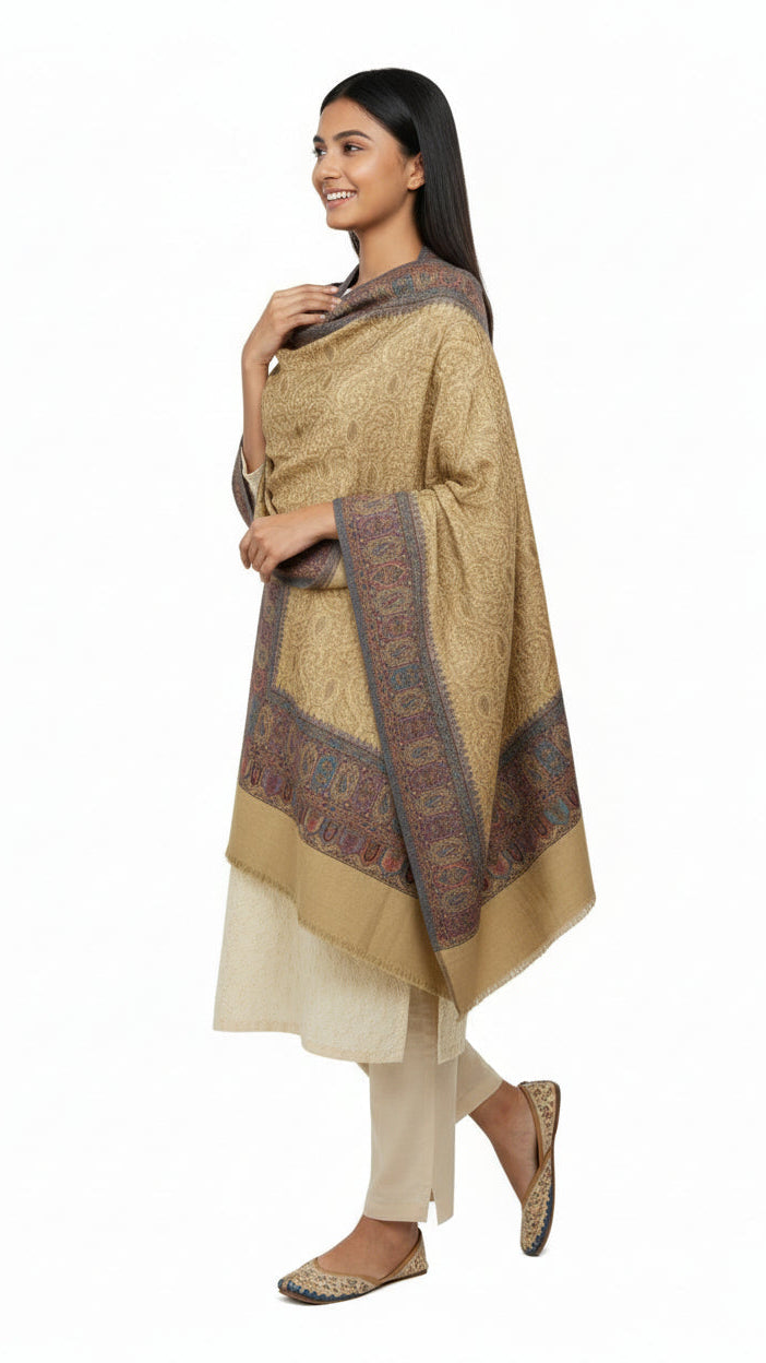 Woman wearing a beige kurta with a patterned shawl on a white background