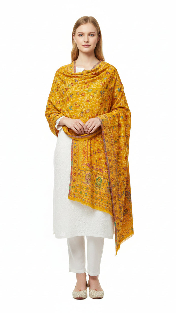 Woman wearing a yellow patterned scarf over a white outfit on a white background