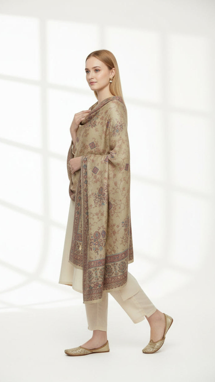 Woman wearing a long, patterned scarf in a bright room with white curtains.