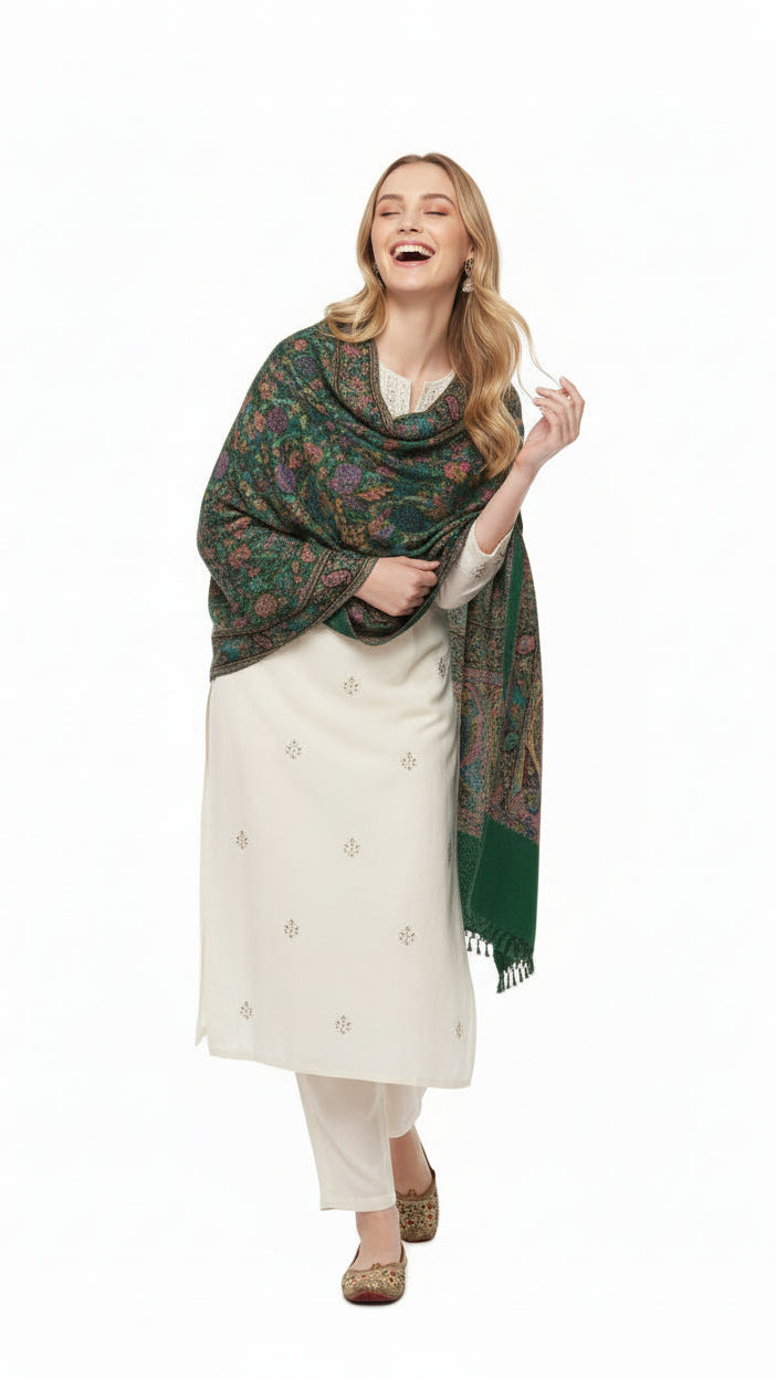 Woman wearing a green floral shawl over a white outfit on a white background