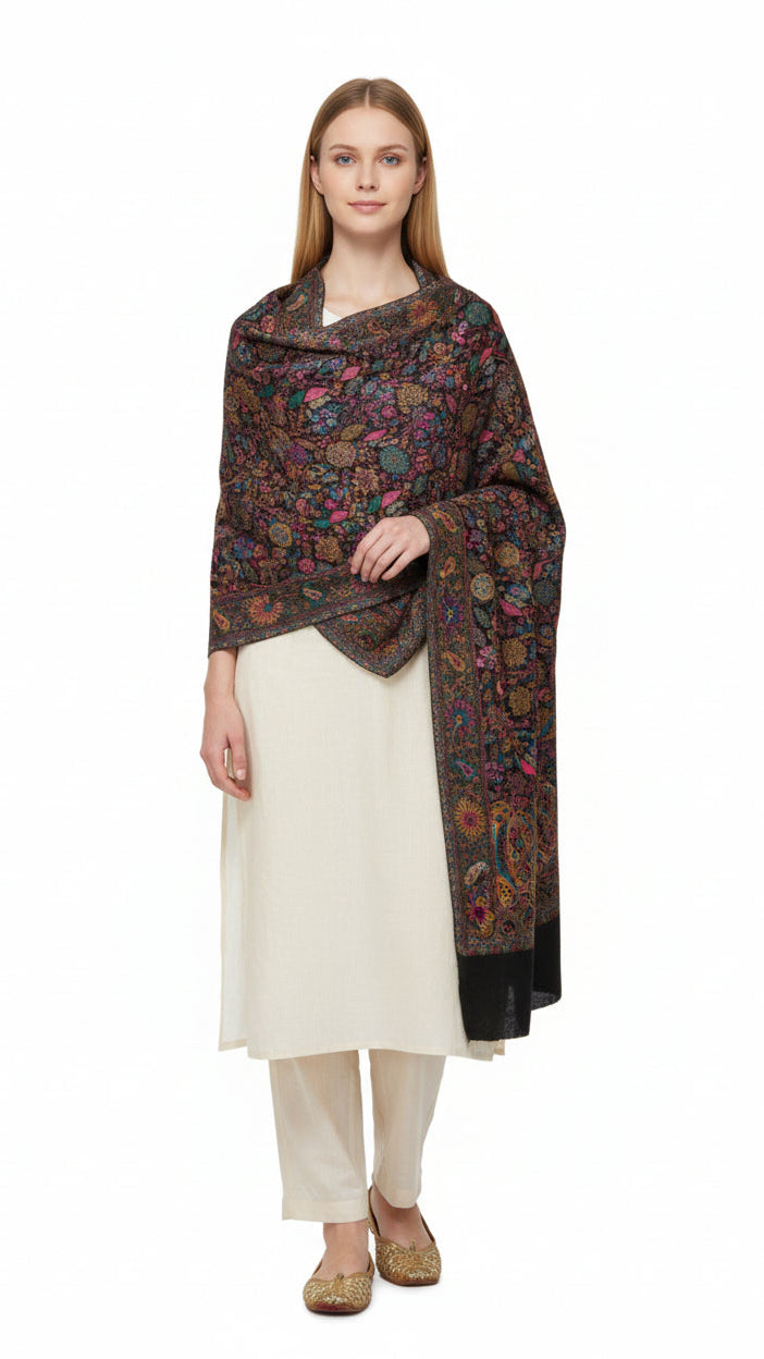 Woman wearing a patterned scarf over a white outfit on a white background