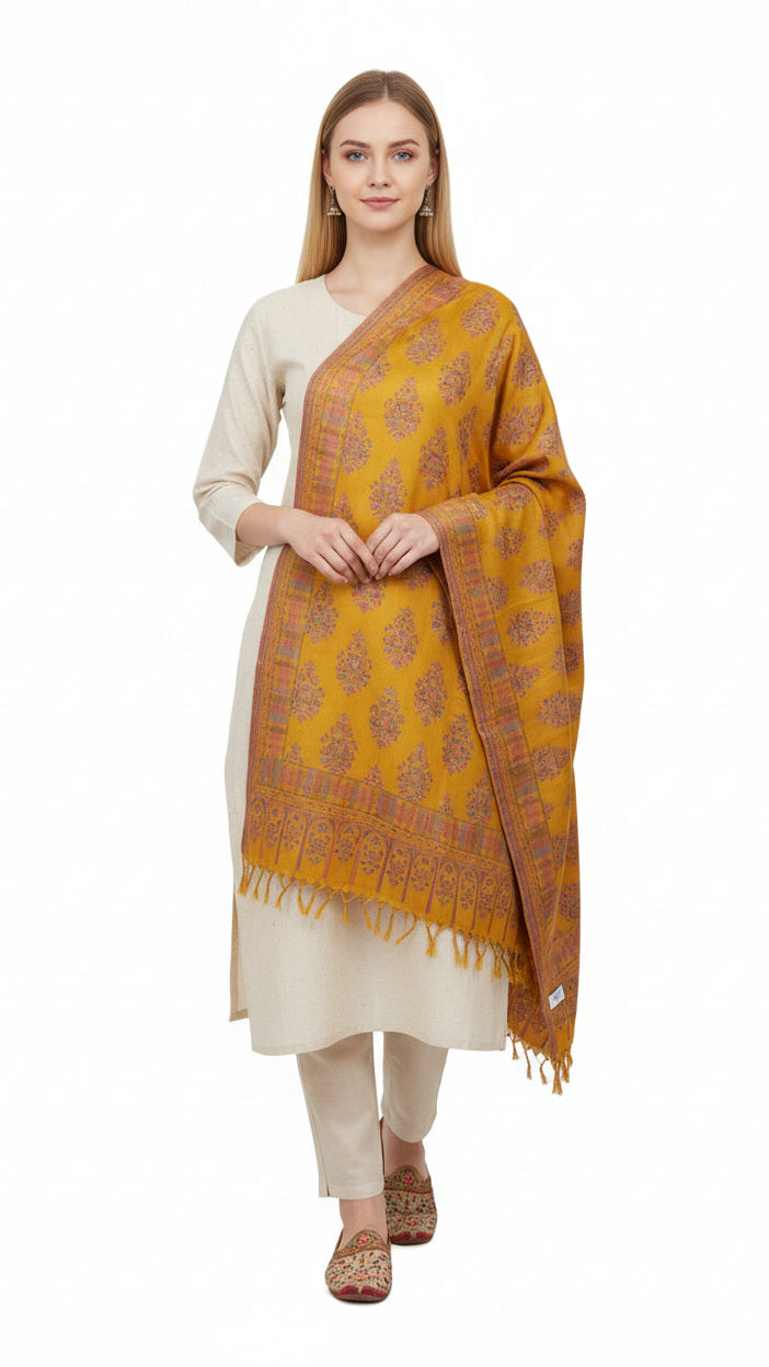 Woman wearing a yellow patterned scarf over a white outfit on a white background