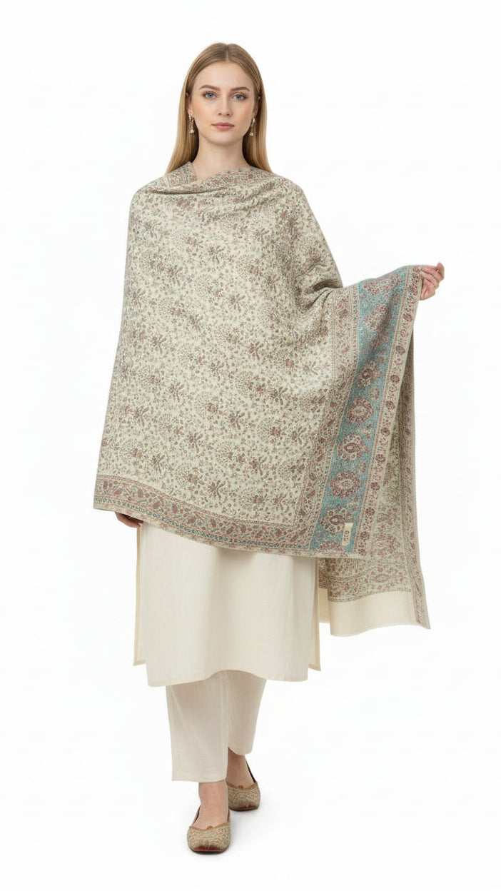 Woman wearing a patterned shawl over a white outfit on a white background